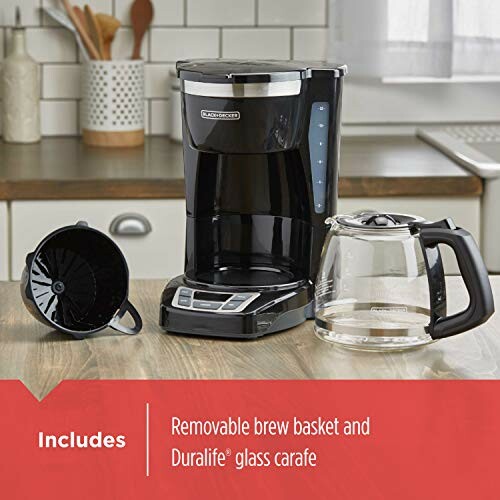 Black coffee maker with removable brew basket and glass carafe on a kitchen counter.